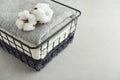 Towels with cotton flowers in black metal basket