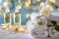 Towels, flowers, and candles on a table create a serene ambiance Royalty Free Stock Photo