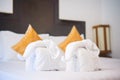 Towels in form of elephants on luxury bed in tropical beach hotel Royalty Free Stock Photo