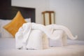 Towels in form of elephants on luxury bed in tropical beach hotel Royalty Free Stock Photo