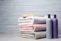 Towels with hair brush and shampoo bottles on table Royalty Free Stock Photo