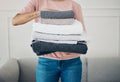 Towels, hands and cleaning with a woman housekeeper closeup in the living room of a home for hygiene. Laundry