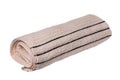 Towels isolated. Closeup of a rolled up beige soft terry bath towel isolated on a white background Royalty Free Stock Photo