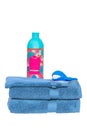 Towels isolated. Closeup of a stack or pile of blue soft terry bath towels with a wash softener and a funny whale isolated on a Royalty Free Stock Photo