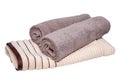 Towels isolated. Closeup of a stack or pile of brown beige soft terry bath towels isolated on a white background Royalty Free Stock Photo