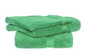 Towels isolated. Closeup of a stack or pile of green soft terry bath towels isolated on a white backgroun Royalty Free Stock Photo