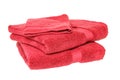 Towels isolated. Closeup of a stack or pile of red soft terry bath towels isolated on a white backgro. Royalty Free Stock Photo
