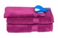 Towels isolated. Closeup of a stack or pile of violet soft terry bath towels with funny whale isolated on a white background Royalty Free Stock Photo