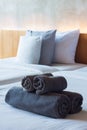 Towels roll on bed in hotel room. Royalty Free Stock Photo