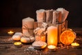 Towels, soap, salt, a slice of dried orange, and burning candles. Spa kit. Royalty Free Stock Photo