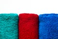Towels of three colors on a white background. Red green and blue Royalty Free Stock Photo