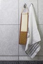 Towels and washcloths hanging on the tiled wall background Royalty Free Stock Photo