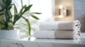 Towels on white marble desk in the foreground and blurred modern bathroom Royalty Free Stock Photo