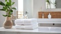 Towels on white marble desk in the foreground and blurred modern bathroom Royalty Free Stock Photo