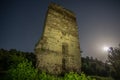 Tower of an ancient castle on a moonlit night