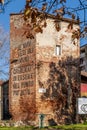 The tower of the ancient city walls of Cascina, Pisa, Italy, with the italian exhortation to look higher Royalty Free Stock Photo