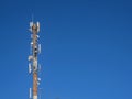 Tower with antennas of cellular communication against the background of the blue sky Royalty Free Stock Photo