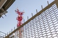 A tower with antennas for mobile communications, fenced off. Antennas against the blue sky. Royalty Free Stock Photo