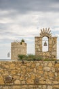 Tower, Arch with bell, stone wall near the sea and beautiful blue sku Royalty Free Stock Photo
