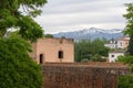 Tower of Baltasar de la Cruz at Alhambra with Sierra Nevada Mountains - Granada, Andalusia, Spain