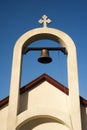 Tower bell of a small stone church against a beautiful cloudy sky. Royalty Free Stock Photo