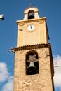 Beautiful bell tower with a clock marking one o`clock