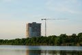 Tower block of flats under construction on lake shore Royalty Free Stock Photo