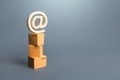 Tower of boxes and email internet symbol. Online Internet distribution of goods. E-commerce. Network marketing advertising