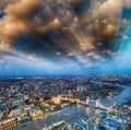 Tower Bridge and city skyline along river Thames at night, aerial view - London - UK Royalty Free Stock Photo