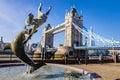 Tower bridge and the Girl with a dolphin fountain in a sunny London