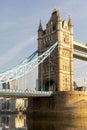 a tower bridge spanning over a river in the sun, Royalty Free Stock Photo