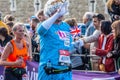 TOWER BRIDGE, LONDON, ENGLAND - 03 October 2021: Participant dressed as the queen running in the Virgin Money London Marathon 2021