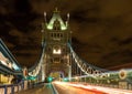 Tower Bridge in London, UK at night with moving red double-decker bus leaving light traces Royalty Free Stock Photo