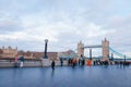 tower bridge and many tourist walking along the queen walk in london at evening, cloudy daytime