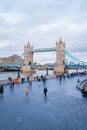 tower bridge and many tourist walking along the queen walk in london at evening, cloudy daytime