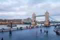 tower bridge and many tourist walking along the queen walk in london at evening, cloudy daytime