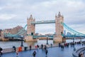 tower bridge and many tourist walking along the queen walk in london at evening, cloudy daytime