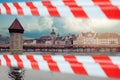 Tower, bridge and river in Lucerne, Switzerland with warning tape. Closed historical european sightseeing