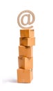 A tower of cardboard boxes and an email symbol on top. The concept of online sales, shopping and online shopping. Realization Royalty Free Stock Photo