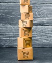 Tower of cardboard boxes with pattern of shopping carts on a blue background. commerce, online shopping. Purchasing power Royalty Free Stock Photo