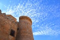 Views of the tower of the castle of Belmonte with intense blue sky with clouds.