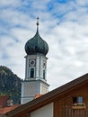 Tower of the Catholic Parish Church of St. Peter and Paul in Oberammergau, Bavaria, Germany Royalty Free Stock Photo