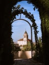 Tower of the church Iglesia de Santa Maria de la Encarnacion in the Alhambra, Granada, from the gardens of Generalife Royalty Free Stock Photo