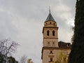 Tower of church of Santa Maria de Alhambra, Granada, Spain, on a cloudy day Royalty Free Stock Photo