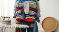 Tower of clean laundry ready for folding next to an ironing board Royalty Free Stock Photo