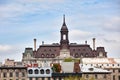 The tower, clock and roof of Montreal city hall hotel de ville against bright cloudy sky in old Montreal, Quebec, Canada Royalty Free Stock Photo