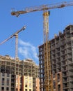 Tower construction crane on the background of blue sky and new buildings. Royalty Free Stock Photo