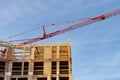 tower construction crane at plywood house construction site Royalty Free Stock Photo