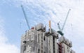 Tower construction crane in rooftop building construction site with blue sky background