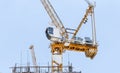 Tower construction crane in rooftop building construction site with blue sky background